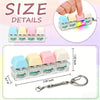 A set of colorful LED macaron keyboard fidget toys packaged with a keychain clip.