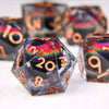 A close-up of a set of liquid core resin dice featuring a dragon eye design, showing various colored and numbered dice.