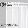 Sheer white voile curtains with a rod pocket and a decorative black hook for easy installation