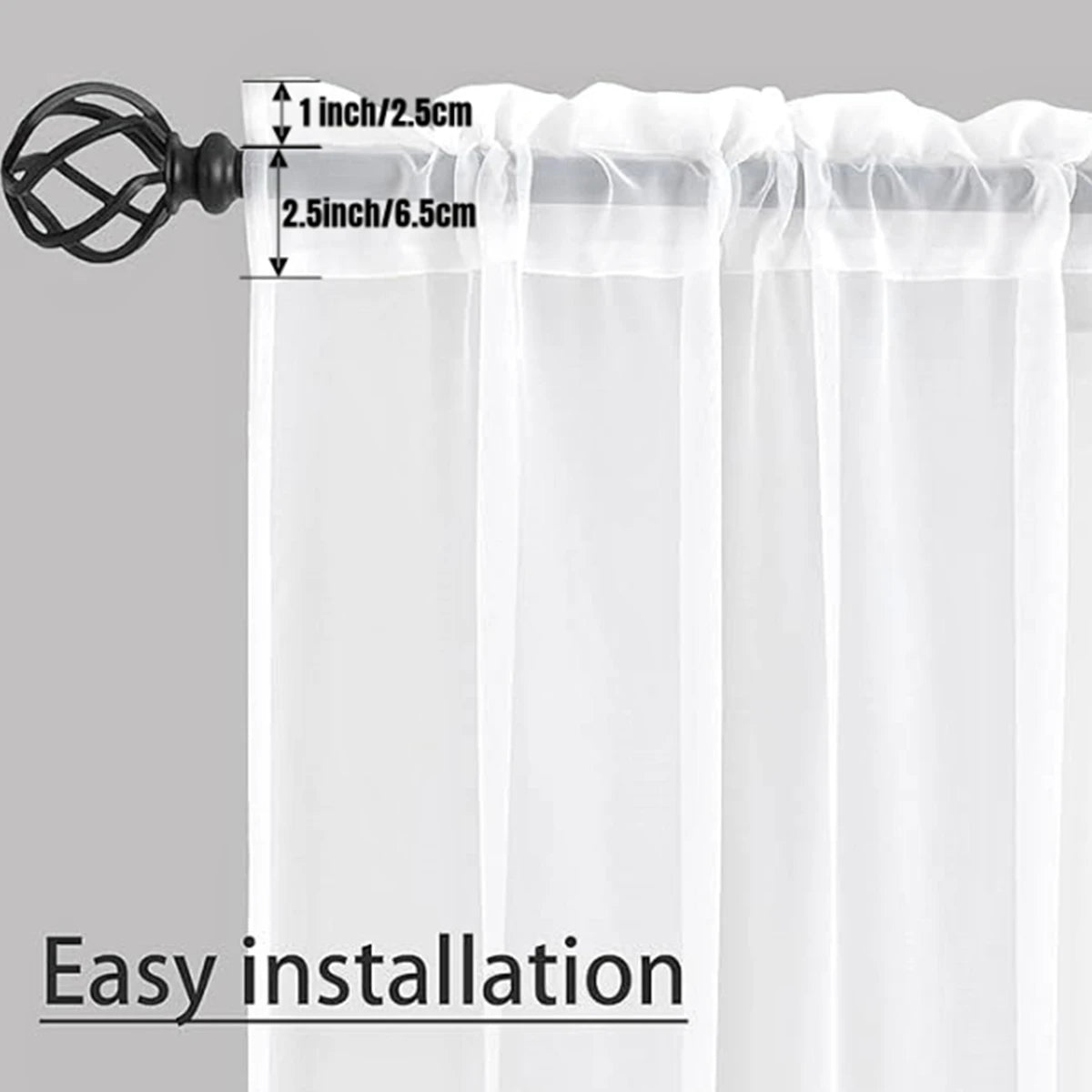 Sheer white voile curtains with a rod pocket and a decorative black hook for easy installation