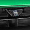 A close-up view of a black camera housing with a silver lens and blue light, mounted on a green surface.