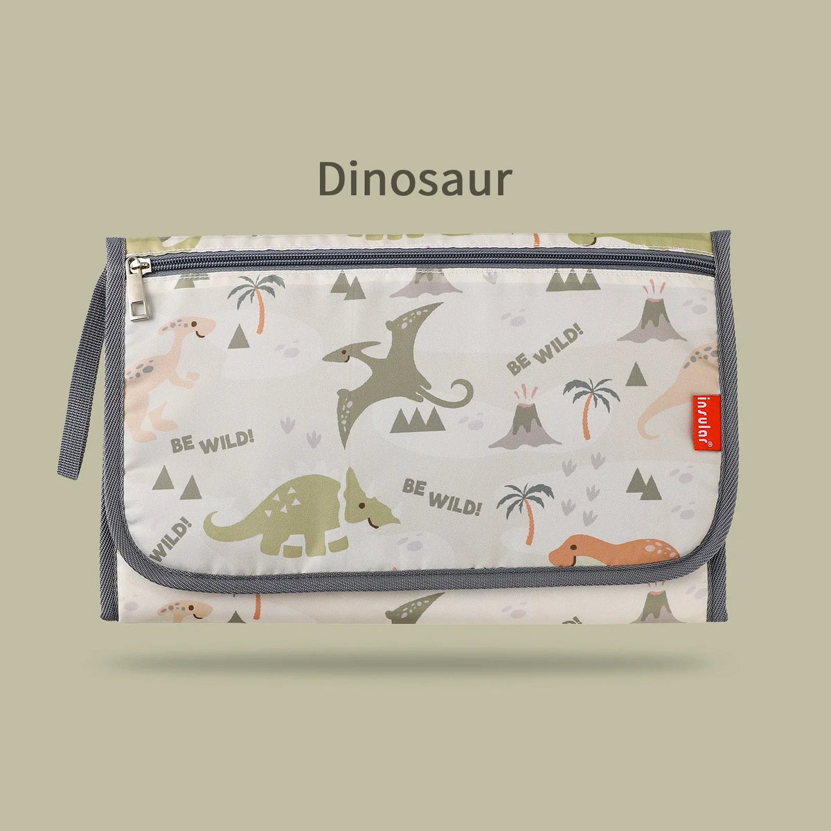 A light-colored fabric storage bag featuring a dinosaur pattern and text, used for a baby changing mat.