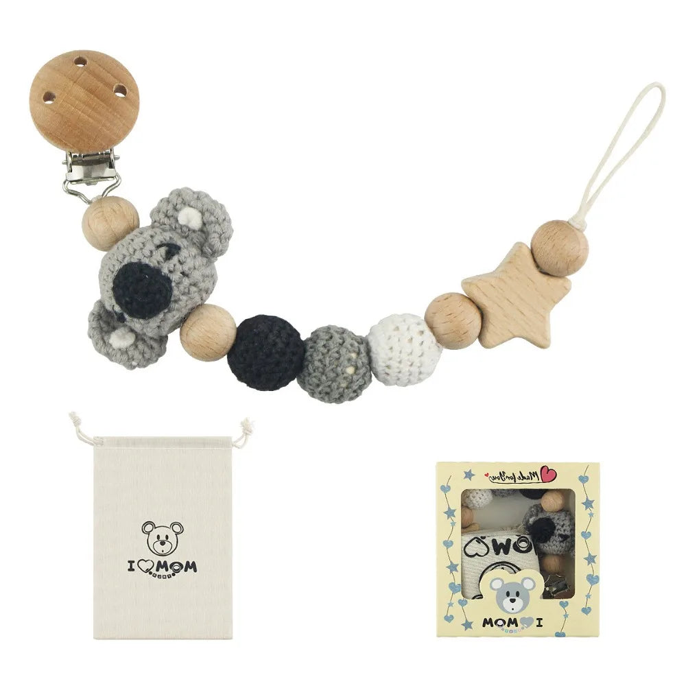 Wooden pacifier clip with a chain of natural wood and gray crochet beads for baby teething