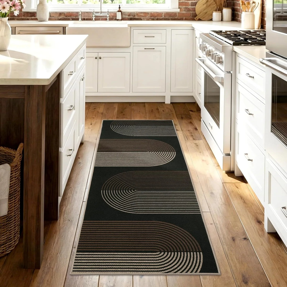 A long runner rug with geometric lines in black and tan stripes placed on a light wood floor.