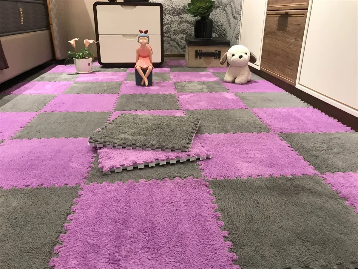 A purple and gray interlocking foam floor mat pattern with a small doll and a white plush toy on the surface.
