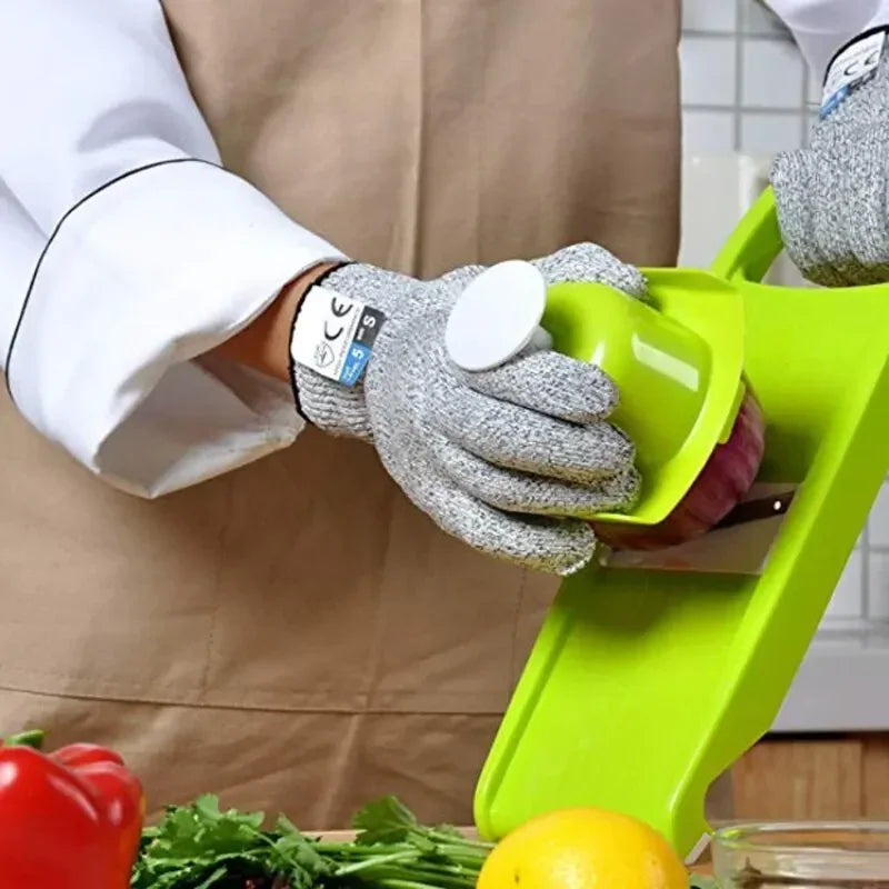 A person wearing white lab coat and protective gloves is cutting a purple vegetable on a green cutting board.