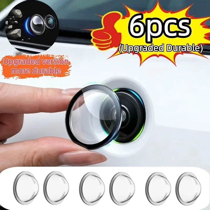 A hand holds a clear protective cover for a car camera, demonstrating the upgraded durable version.