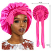 A pink silky satin sleep cap with a wide band shown on a model's head and a separate product view.