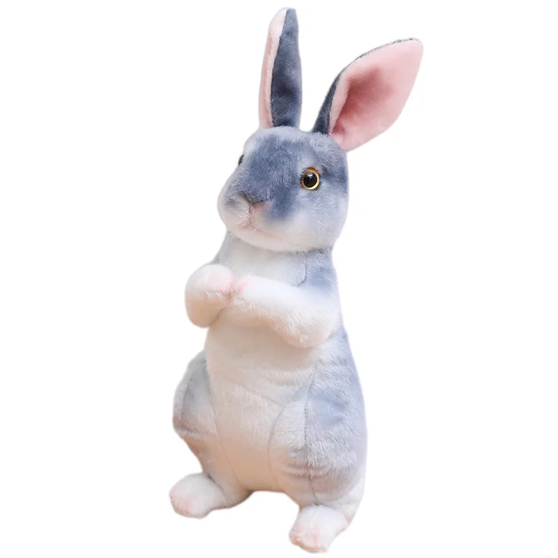 A gray and white plush rabbit stuffed animal with pink ears looking forward.