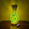 A handcrafted Turkish mosaic table lamp with a warm LED glow, featuring a green and yellow geometric design.
