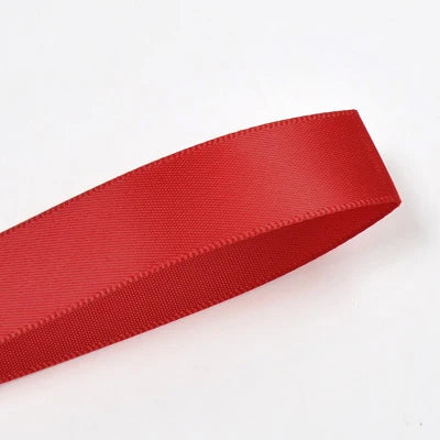 A roll of red double face satin ribbon, approximately 25 yards long.