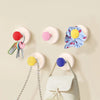 A collection of colorful suction cup hooks for keys and other items displayed against a light background.