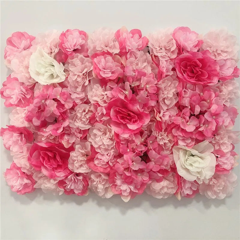 A dense wall panel of pink and white silk rose flowers for weddings and events.