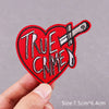 Red heart shaped embroidered patch with the text True Crime and a crossed knife design