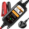 A black 12V automatic battery charger and maintainer unit with a DC output plug is shown.