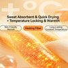 Close-up of an orange heating fiber fabric showing a honeycomb texture and glowing with warmth.