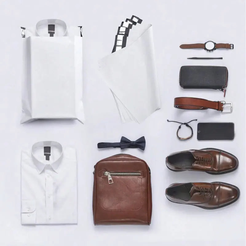 A collection of self-adhesive waterproof mailing bags, a watch, a wallet, and leather shoes.