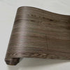 A close-up view of a brown wood grain PVC self-adhesive decal roll.