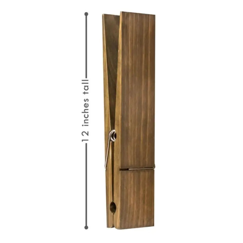 A rustic wooden wall-mounted towel clip with a vertical design and a metal hook.
