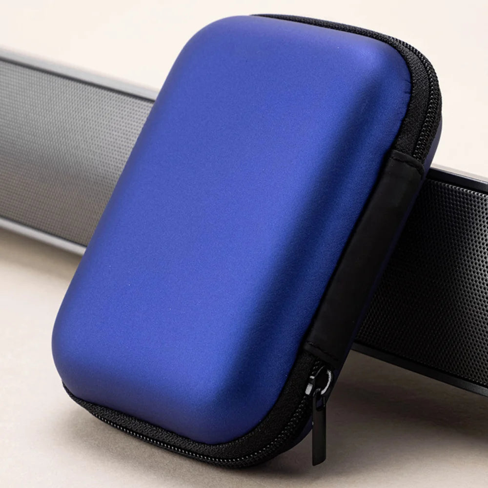 A blue hard EVA protective case for a SanDisk Extreme portable SSD, shown with a black strap.