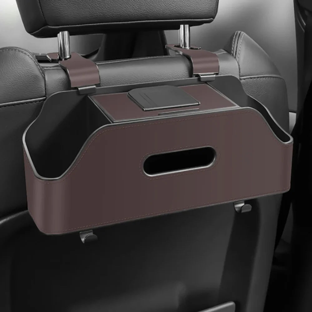 A car back seat organizer featuring a cup holder, trash bin, and phone mount in a brown leather-like material.