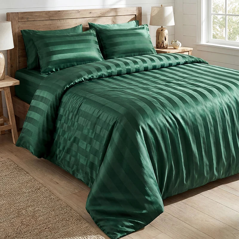 A dark emerald green satin striped jacquard duvet cover set displayed on a bed with natural wood accents.