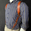 A man's blue striped shirt worn with genuine leather double shoulder suspenders.