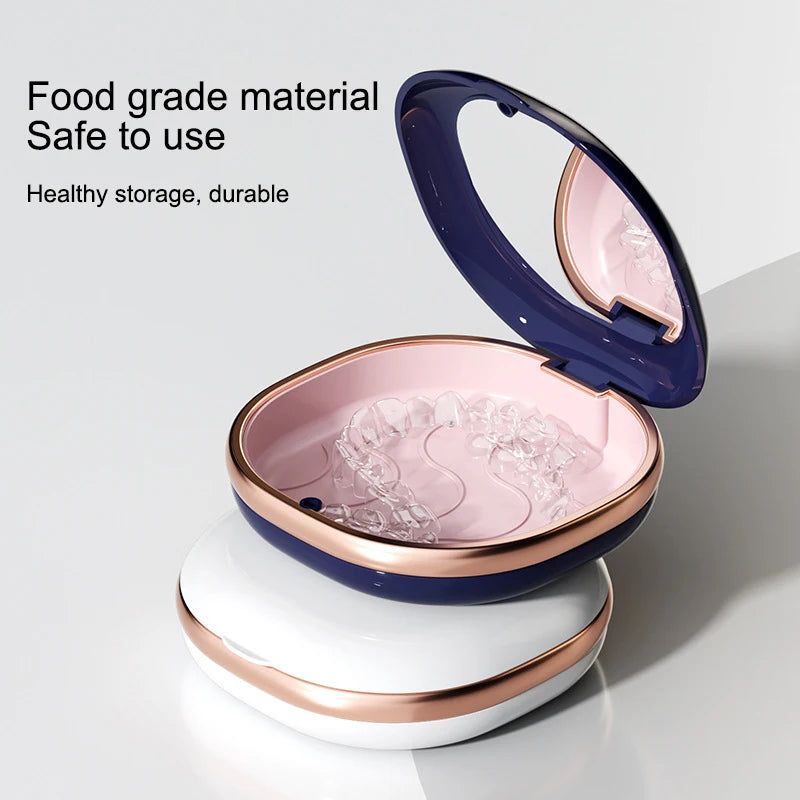 A blue and pink compact orthodontic retainer case with a hinged lid is shown on a white stand.