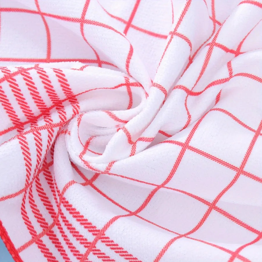 White fabric with a red checkered pattern, folded and draped.