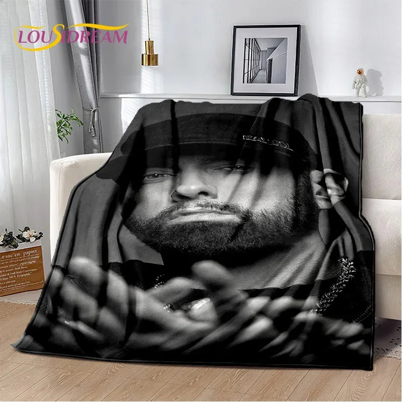A black throw blanket featuring a dramatic, black and white portrait of Eminem and 2Pac.