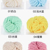 Six balls of chunky acrylic yarn in white, light blue, mint green, yellow, beige, and pink.