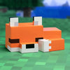 An officially licensed video game fox night light desk lamp in warm orange glow resting on a green surface.