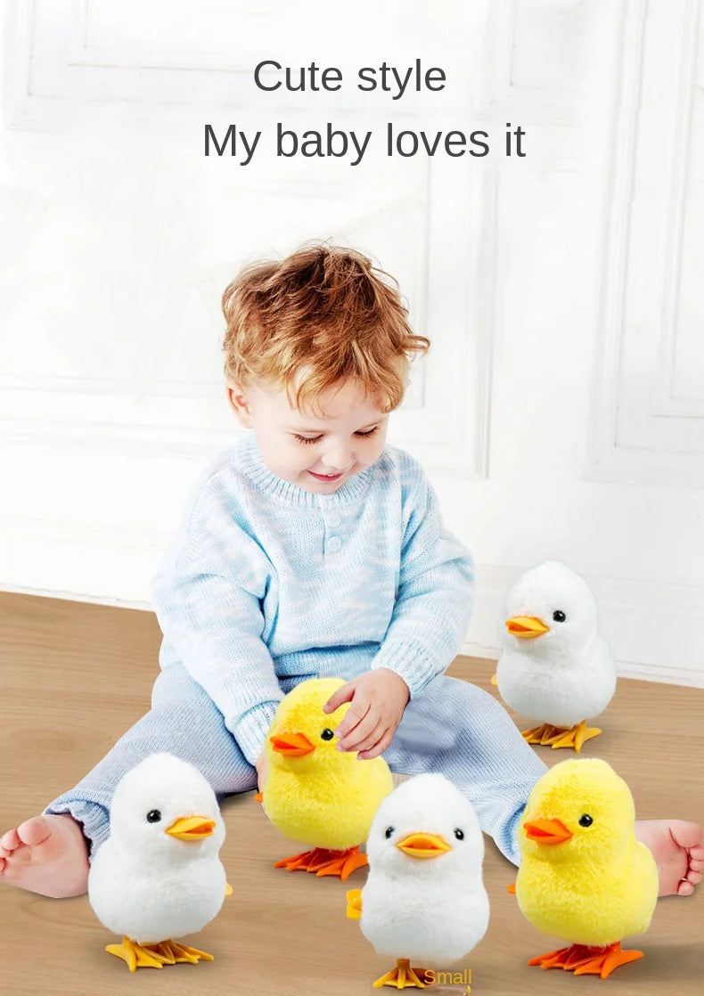 A toddler is playing with a yellow wind-up walking chicken toy and several white chicks.