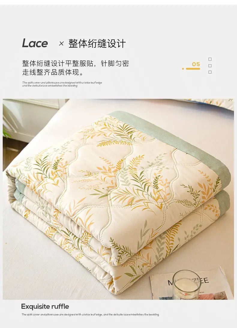 A stack of white and green quilted fabric featuring a delicate lace pattern.