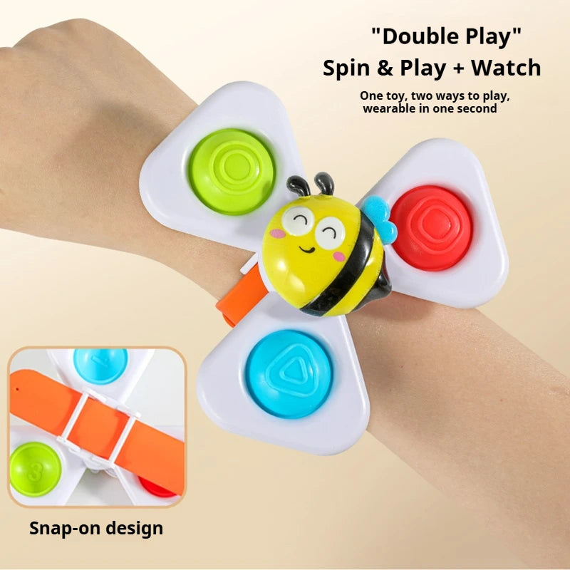 A hand is wearing a white fidget toy with an attached watch band, demonstrating the double play feature.