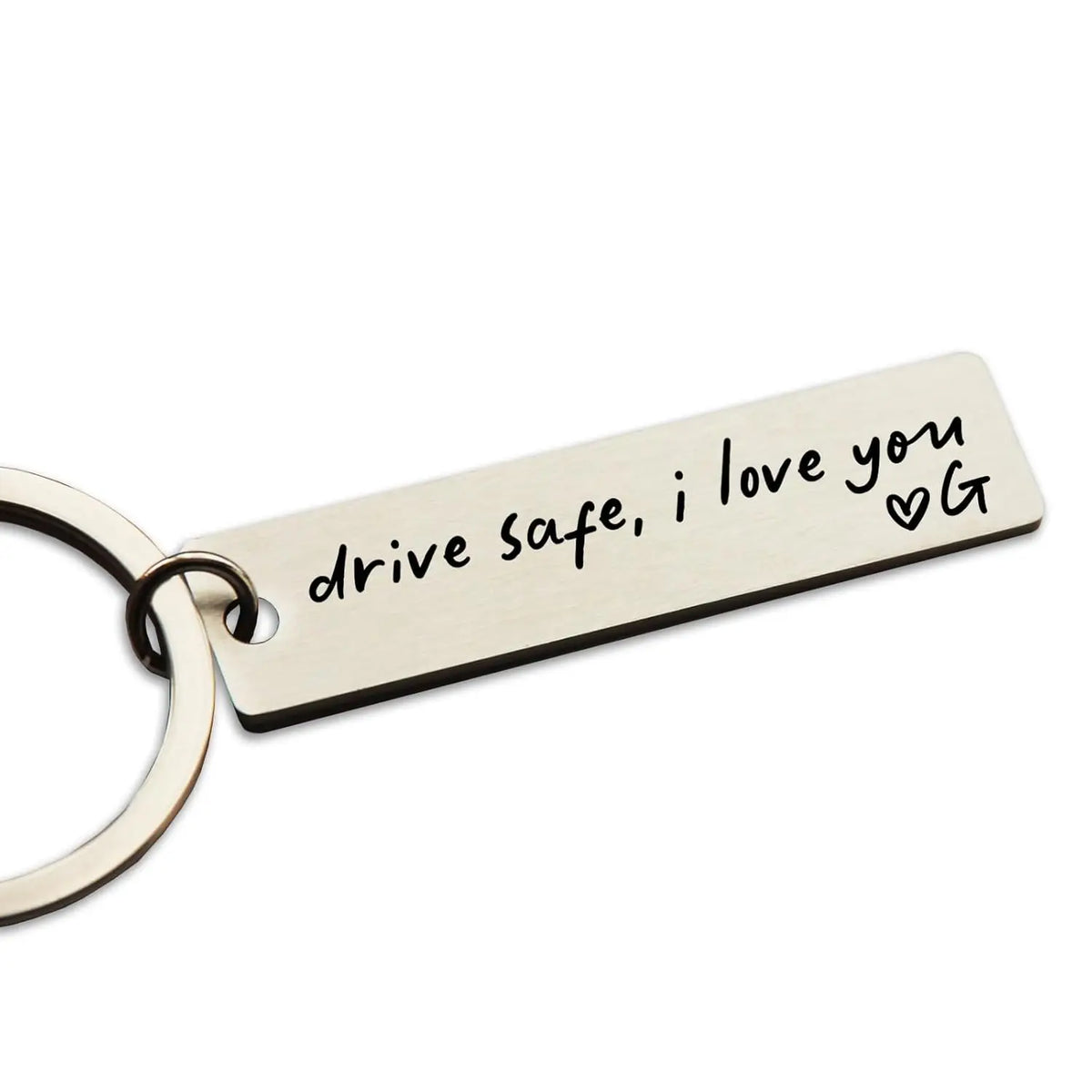 A personalized stainless steel keychain tag engraved with the message drive safe i love you and a heart symbol.