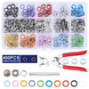 A set of metal snap fasteners and a pair of pliers tool with various colored rings.