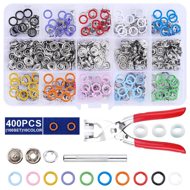 A set of metal snap fasteners and a pair of pliers tool with various colored rings.