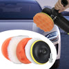 A set of six orange and white car polishing pads with a drill adapter shown next to a car body.