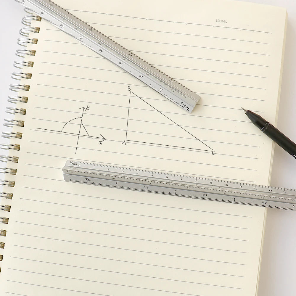 A drawing in a notebook showing a right triangle labeled A, B, and an angle, measured with a metal ruler.