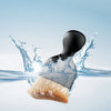 A soft-bristle cleaning brush is shown dipping into clear water, creating splashes and ripples.