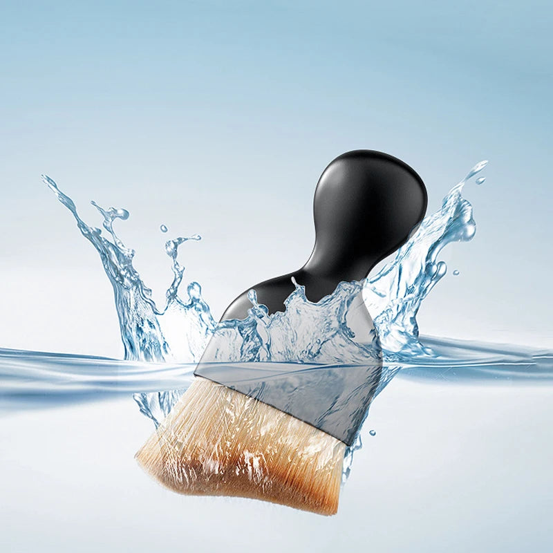 A soft-bristle cleaning brush is shown dipping into clear water, creating splashes and ripples.