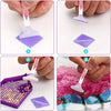 Diamond painting accessory kit showing tools, storage box, and a finished piece on fabric.