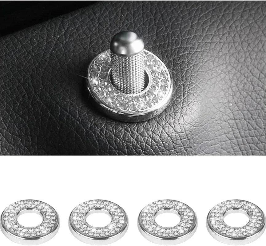 A set of four crystal rhinestone car door lock pull covers displayed against a dark leather surface.