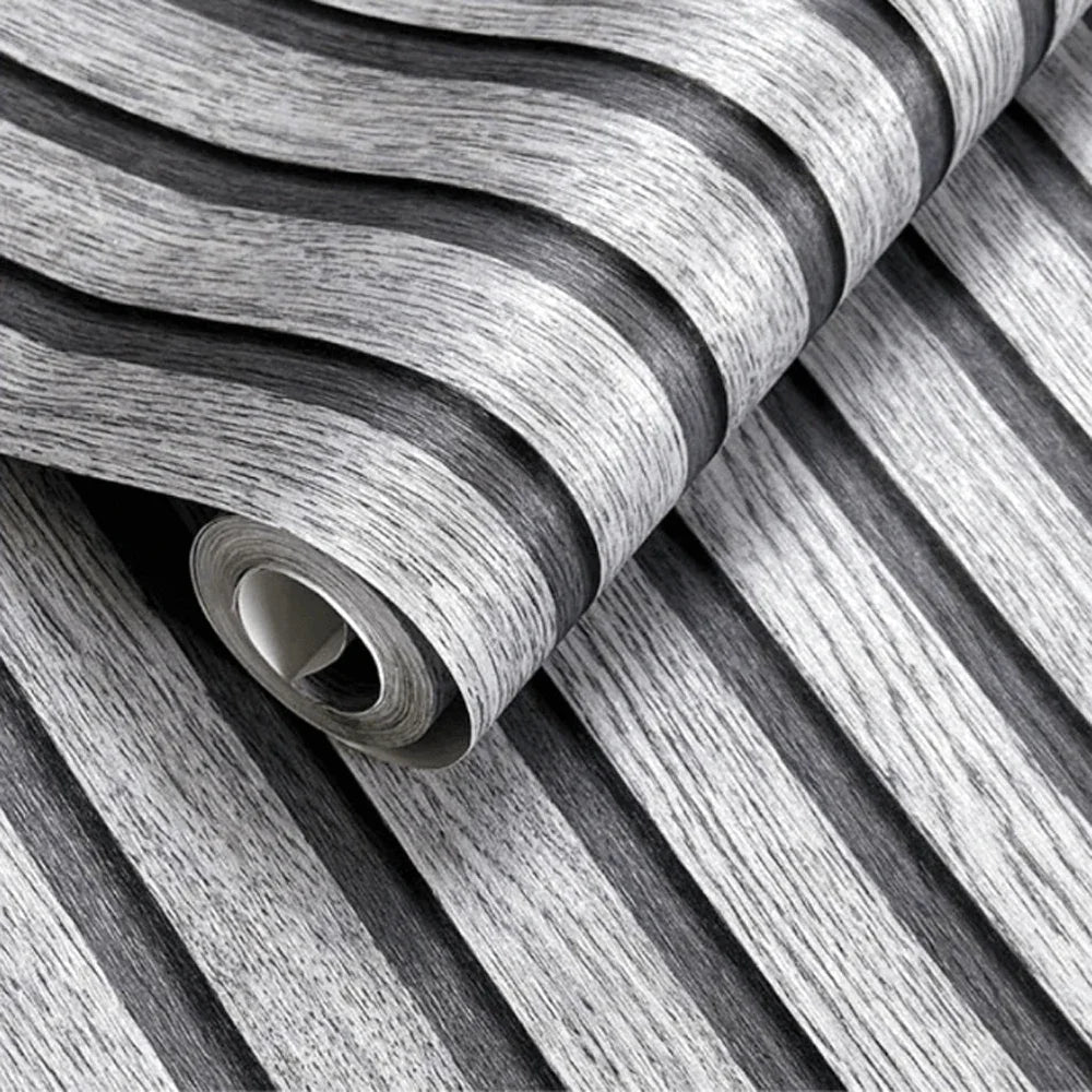 Roll of wood grain self-adhesive wallpaper showing vertical stripes in gray and white.