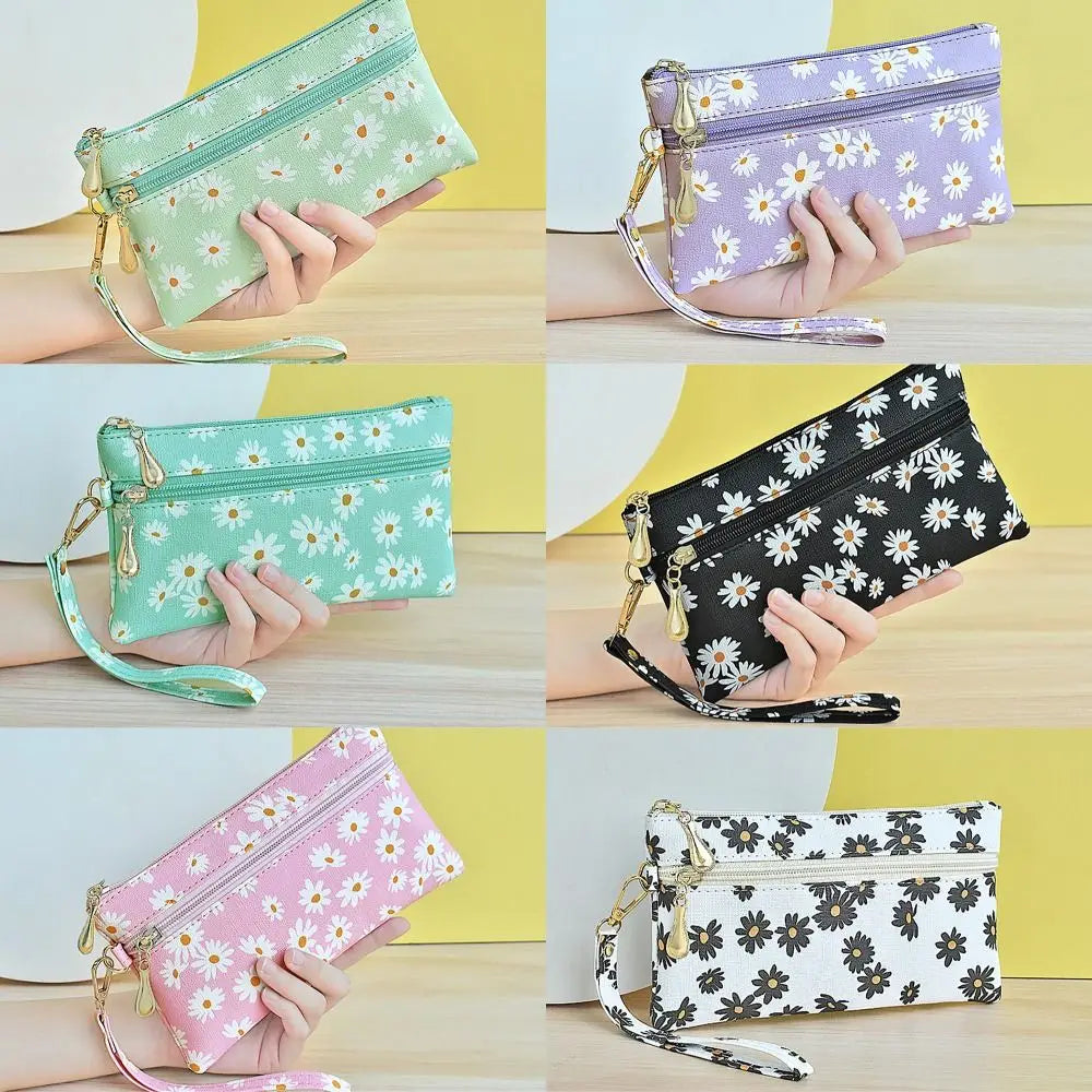 A collection of floral print PU leather wristlet wallets in various shades of green, purple, and black.