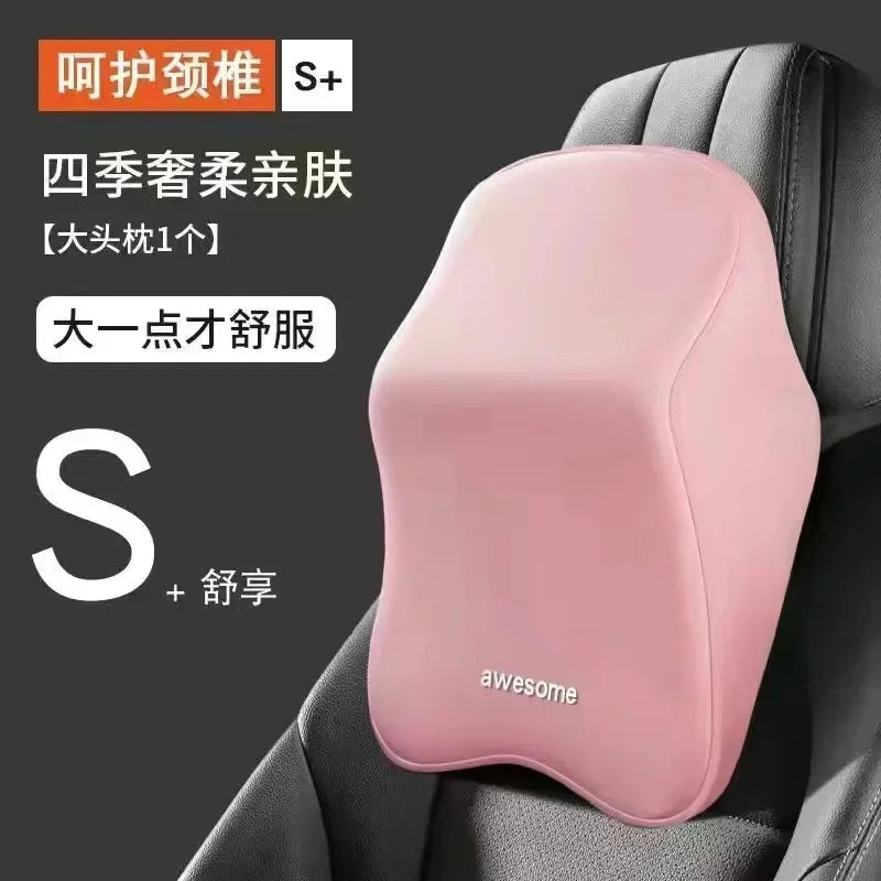 Pink memory foam car headrest and lumbar support pillow placed in a gray car seat.