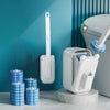 A white wall-mounted disposable toilet brush set with a long handle and replaceable heads displayed on a marble surface.