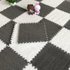 Two small plush bears sitting on a gray and white checkered soft interlocking floor tile pattern.