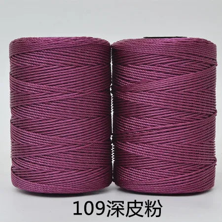 Two spools of magenta 3-ply polyester knitting yarn for crochet and hand crafts